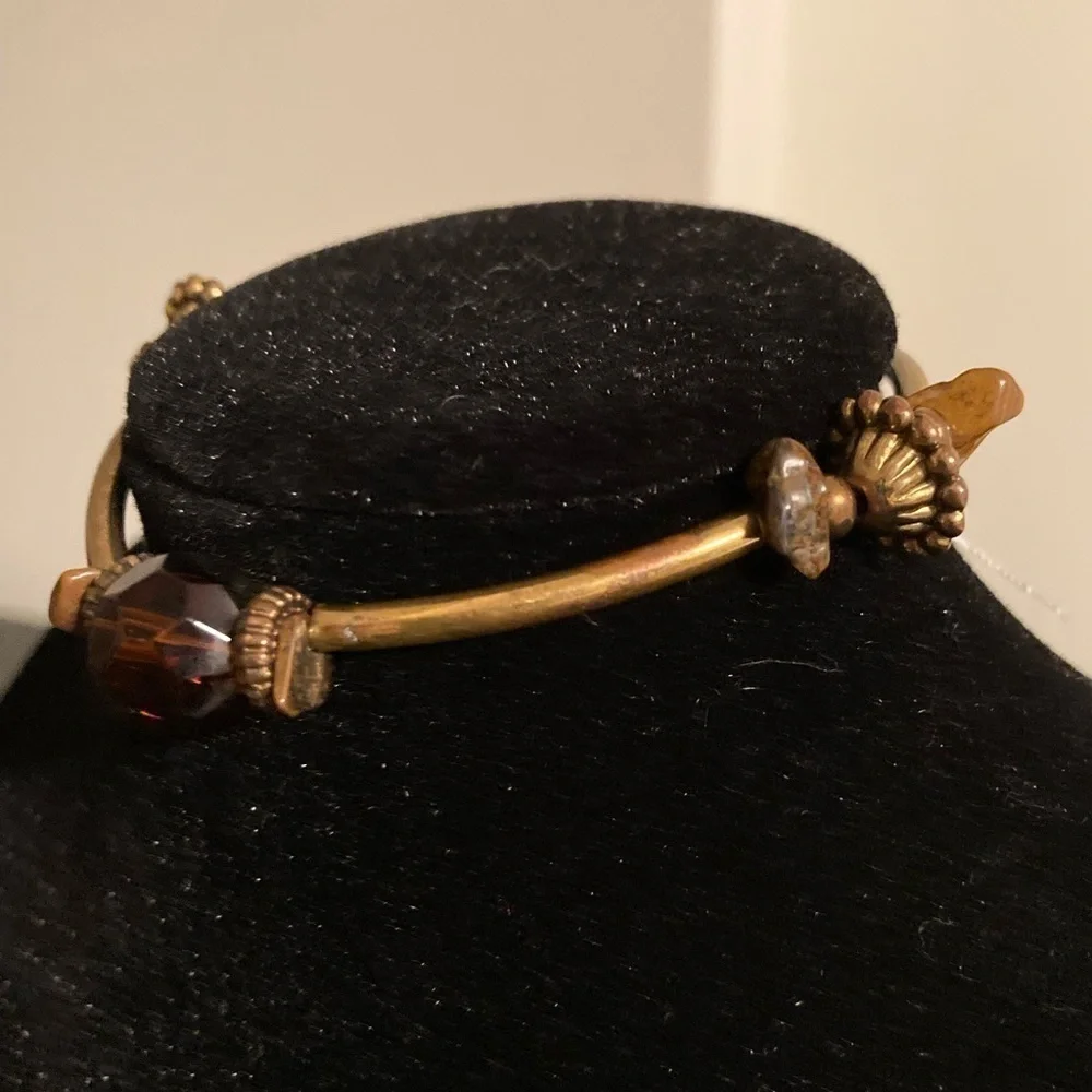 Golden and brownish/orange beaded bracelet. Stretchy.